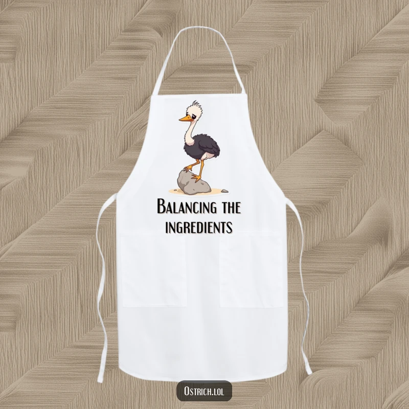 Funny apron showing a wobbly ostrich character attempting to balance a small rock, ideal for humorous kitchen activities.