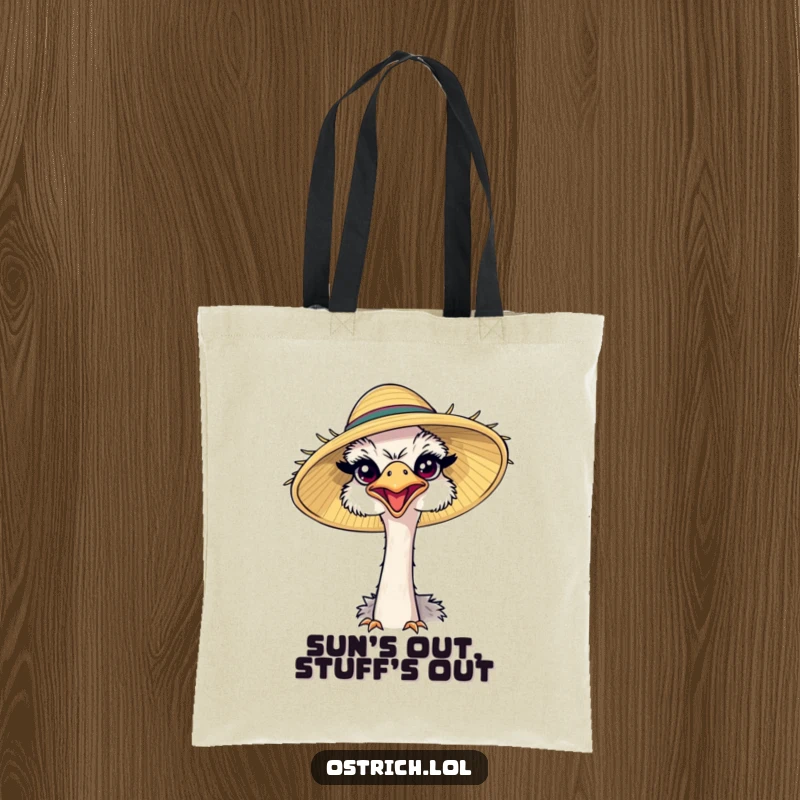 Funny ostrich sporting a comically large sun hat, squinting happily on a tote bag, ideal for carrying essentials with joy.